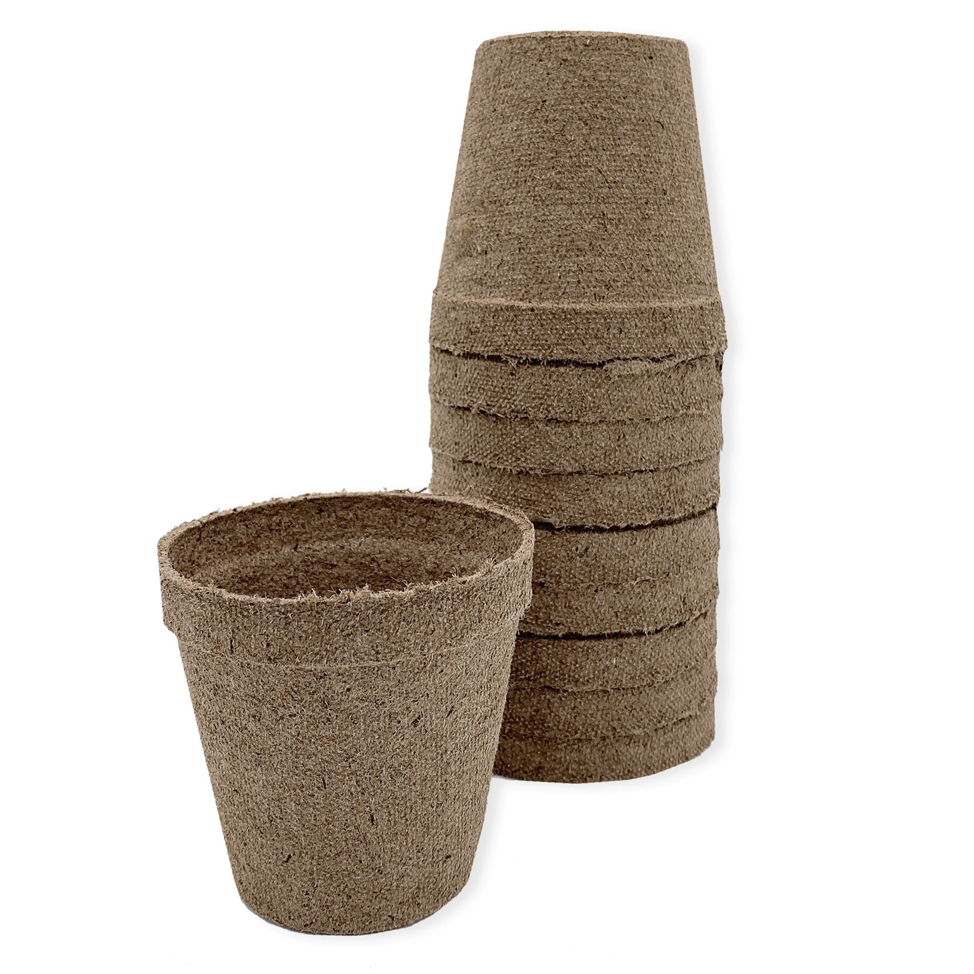 A stack of brown 3 inch Jiffy biodegradable peat pots